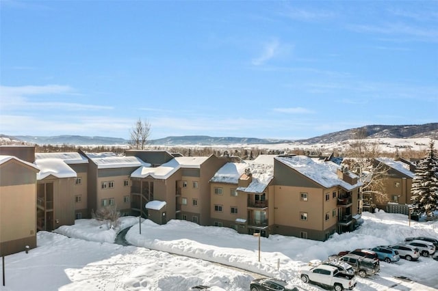 snowy aerial view with a mountain view