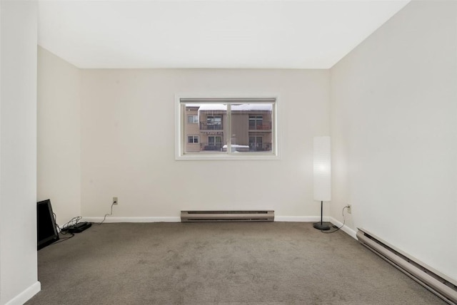 spare room featuring carpet and a baseboard radiator