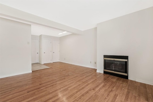 unfurnished living room with light hardwood / wood-style flooring