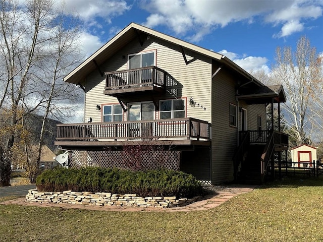 back of house with a yard, a balcony, and a wooden deck