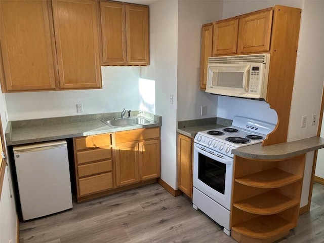 kitchen featuring light wood-type flooring, white appliances, and sink