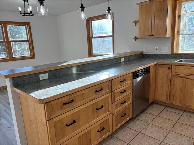 kitchen with dishwasher, light tile patterned flooring, kitchen peninsula, and hanging light fixtures