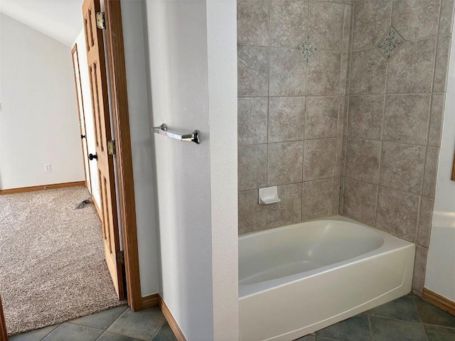 bathroom with tile patterned floors and a bathing tub