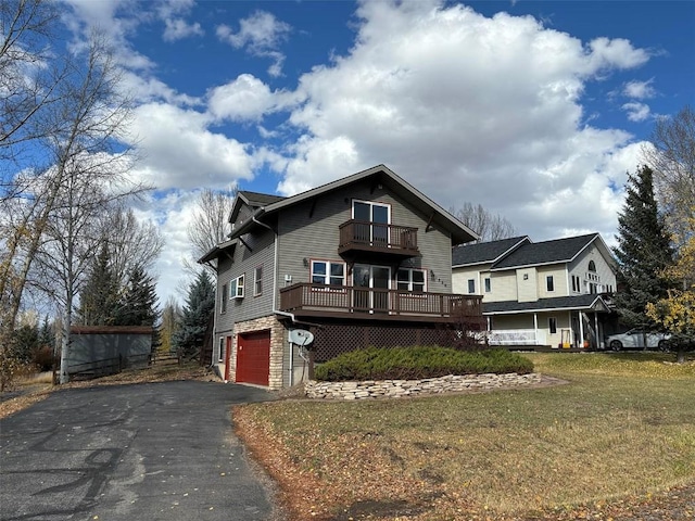 view of front of house with a garage, a deck, a balcony, and a front yard