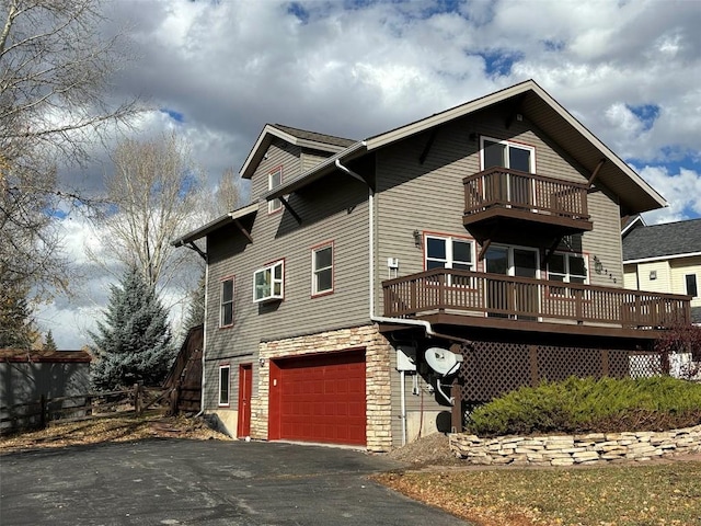 exterior space featuring a balcony and a garage