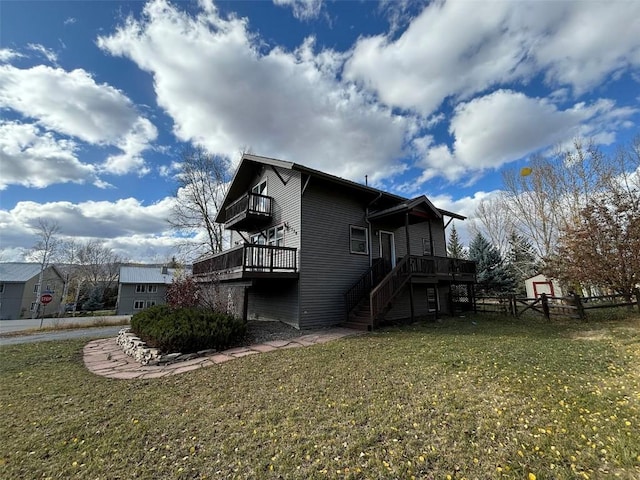 view of property exterior with a balcony, a yard, and a wooden deck