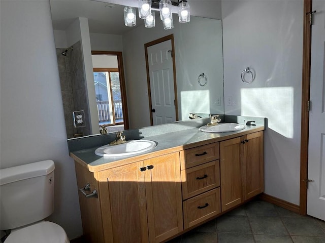 bathroom with tile patterned flooring, vanity, and toilet