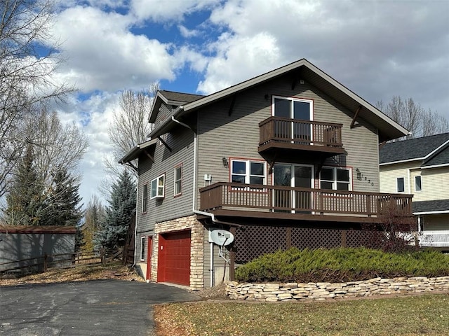 exterior space with a balcony and a garage