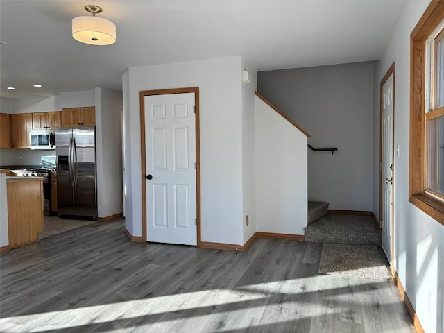 interior space with black range, stainless steel fridge, and light hardwood / wood-style floors