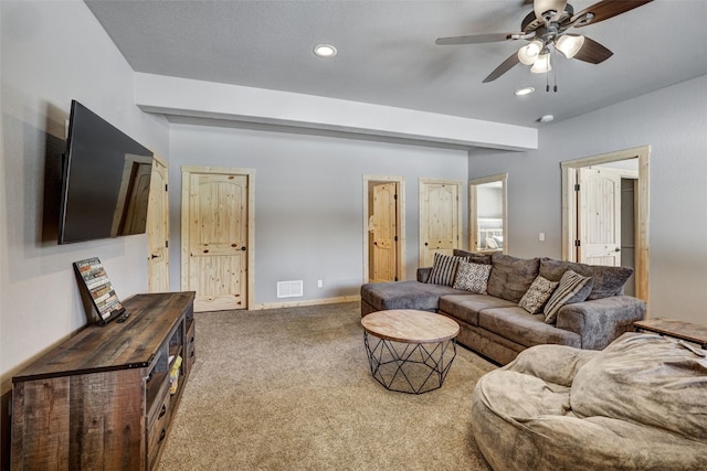 carpeted living room with ceiling fan