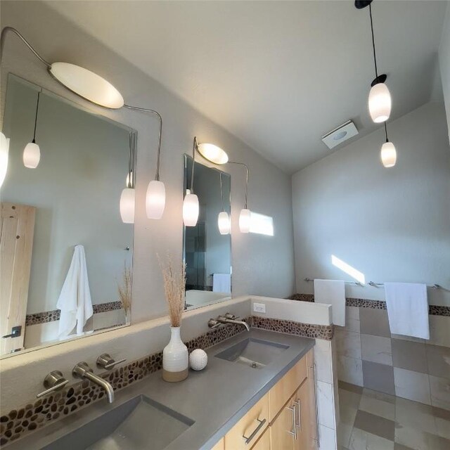 bathroom with lofted ceiling and vanity