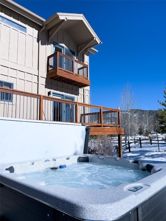 exterior space featuring a balcony and a hot tub