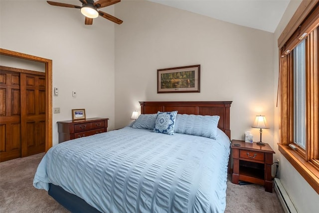 carpeted bedroom with high vaulted ceiling, baseboard heating, and ceiling fan