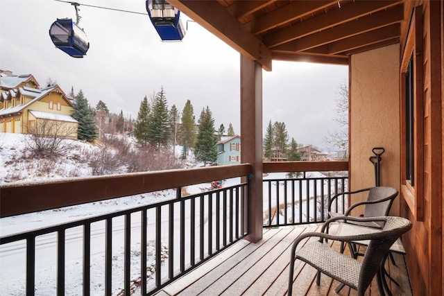 view of snow covered back of property