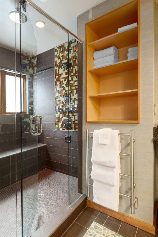 bathroom featuring tile patterned floors and a shower with door