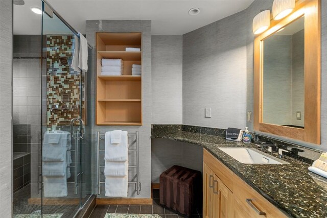 bathroom with vanity and a shower with shower door