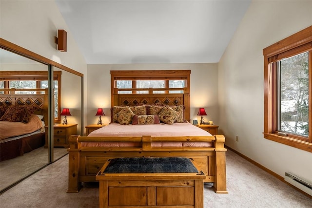 carpeted bedroom featuring vaulted ceiling, multiple windows, a baseboard heating unit, and a closet