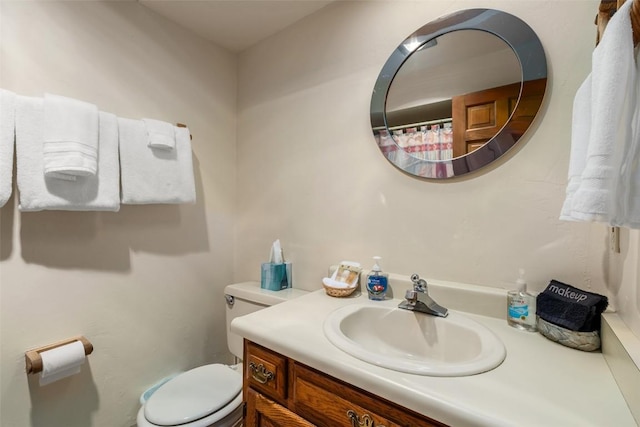 bathroom featuring toilet and vanity