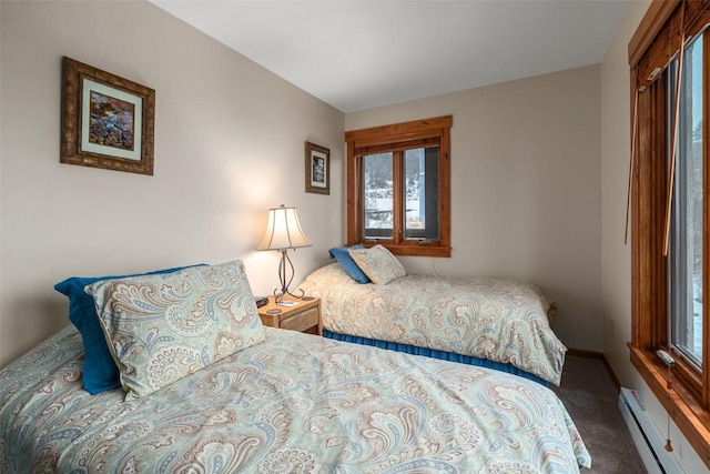 carpeted bedroom featuring a baseboard radiator