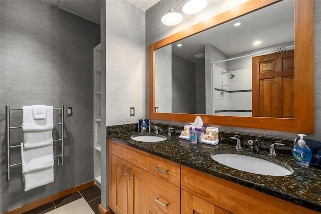 bathroom featuring tile patterned floors, vanity, and walk in shower