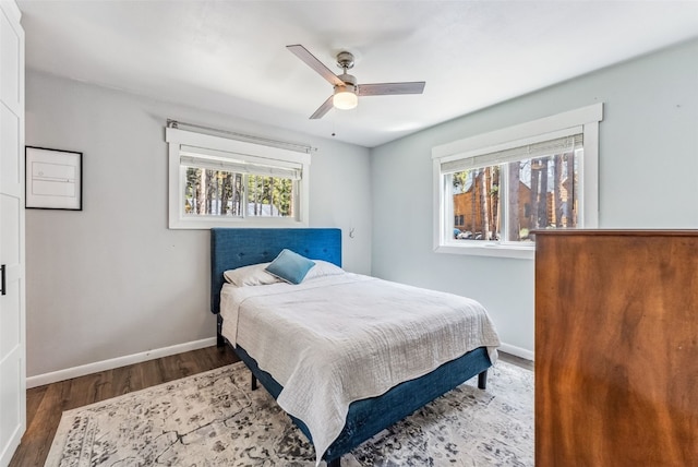 bedroom featuring dark wood-style floors, ceiling fan, and baseboards