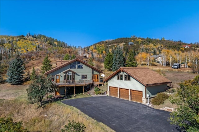 view of front of house with a deck and a garage