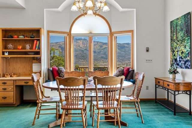 carpeted dining room with an inviting chandelier, a mountain view, and built in desk