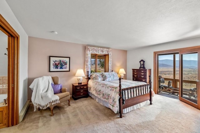 bedroom with light carpet, a mountain view, and access to outside