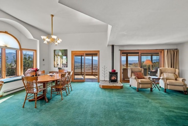 carpeted dining space featuring a wood stove, an inviting chandelier, and baseboard heating