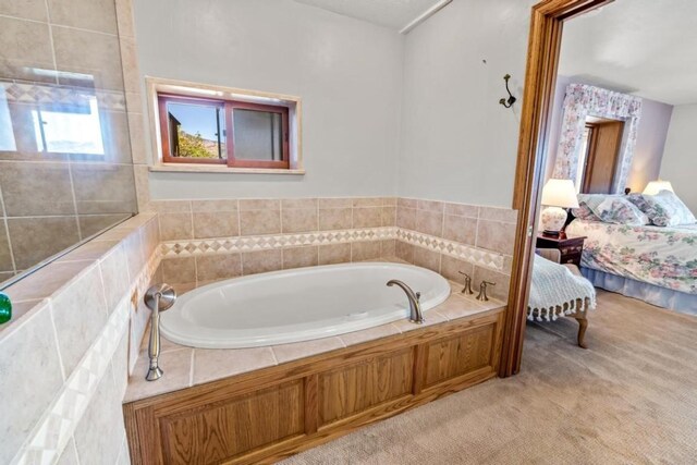 bathroom featuring a relaxing tiled tub