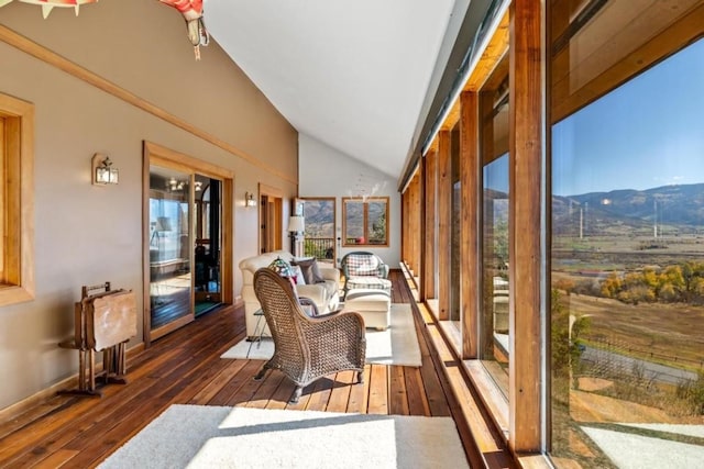 sunroom / solarium with vaulted ceiling and a mountain view