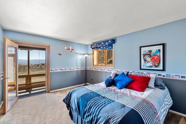 bedroom featuring carpet flooring and access to exterior