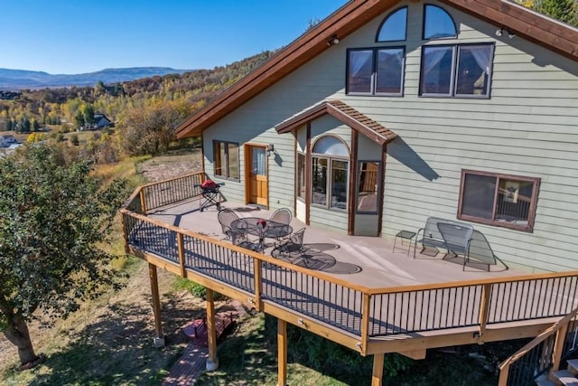 back of house with a deck with mountain view