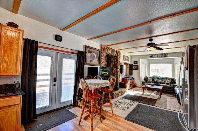 dining area featuring ceiling fan, french doors, and light wood-type flooring