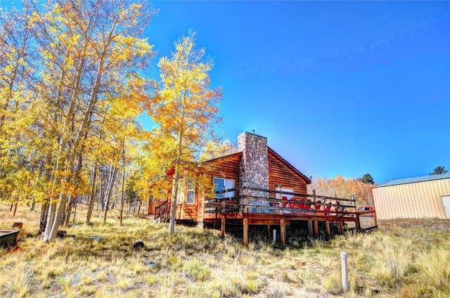 rear view of property with a wooden deck