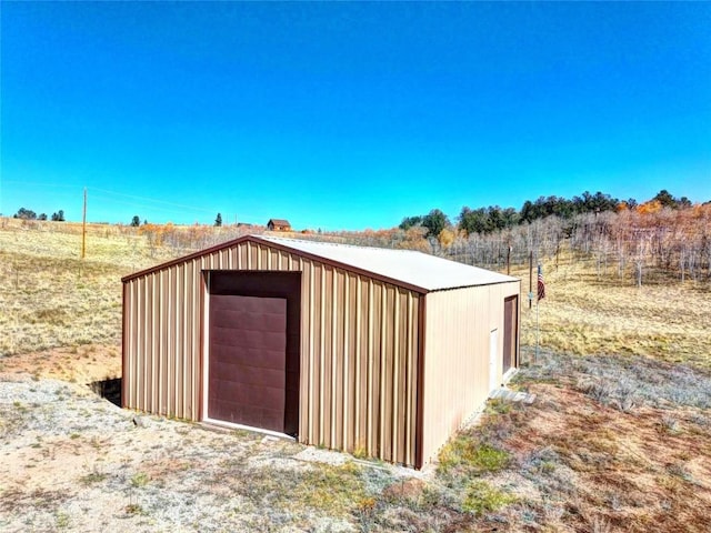 view of outbuilding featuring a rural view