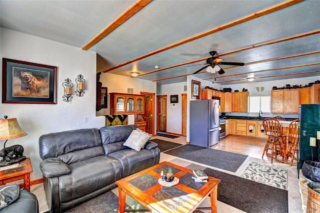 living room featuring ceiling fan and sink