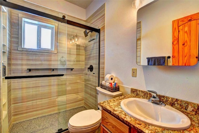 bathroom with an enclosed shower, vanity, and toilet