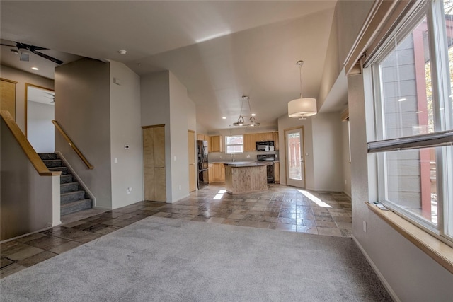 unfurnished living room with light carpet, ceiling fan, and lofted ceiling