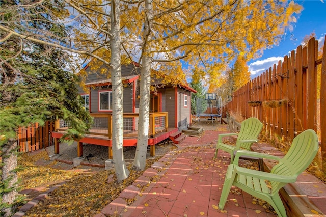 view of patio / terrace featuring a trampoline and a deck