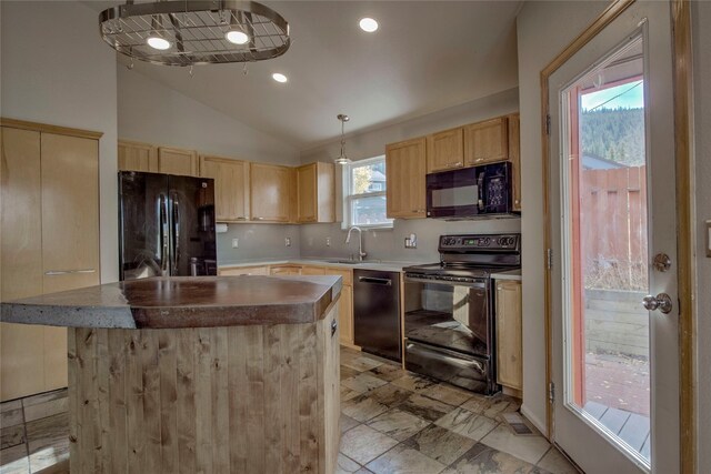 kitchen with pendant lighting, lofted ceiling, black appliances, sink, and a kitchen island