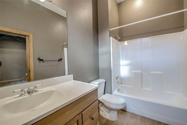 full bathroom featuring wood-type flooring, vanity, toilet, and shower / washtub combination