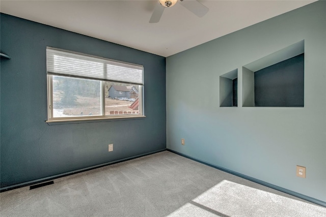 carpeted empty room featuring ceiling fan