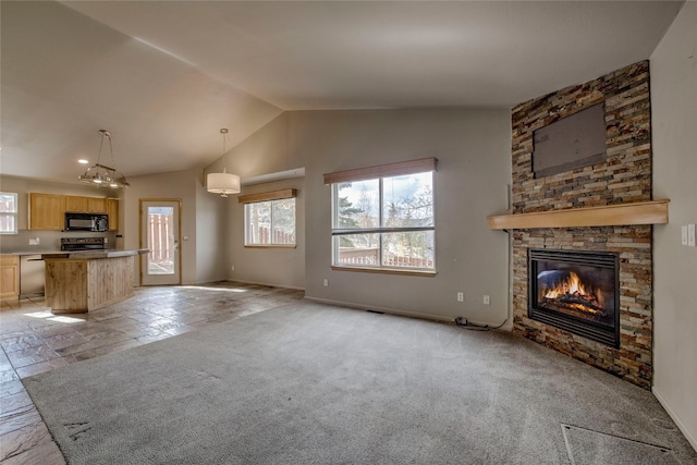 unfurnished living room featuring vaulted ceiling, light colored carpet, and a stone fireplace