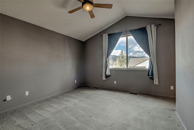 carpeted empty room with ceiling fan and lofted ceiling