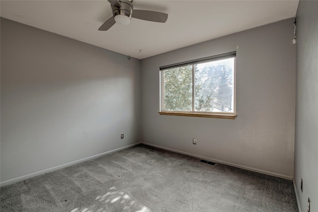 spare room featuring ceiling fan and light colored carpet