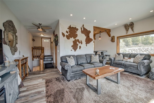 living room featuring light wood-type flooring and ceiling fan