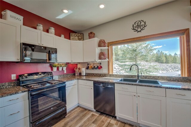 kitchen featuring beam ceiling, white cabinetry, dishwasher, and sink