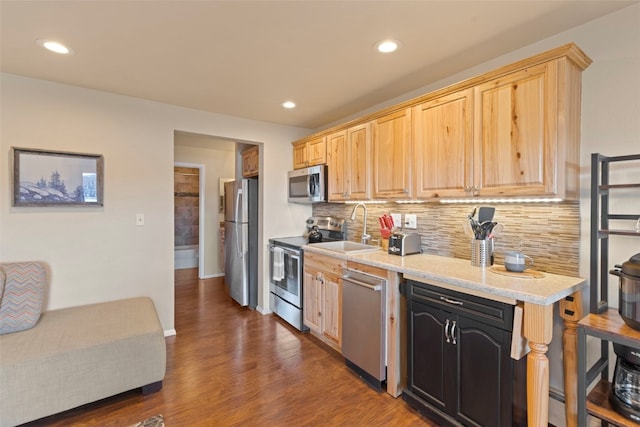 kitchen with light brown cabinetry, backsplash, stainless steel appliances, dark wood-type flooring, and sink