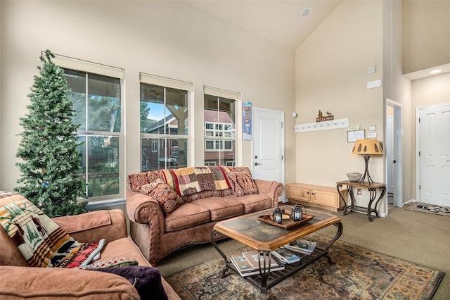 living room featuring carpet flooring and high vaulted ceiling